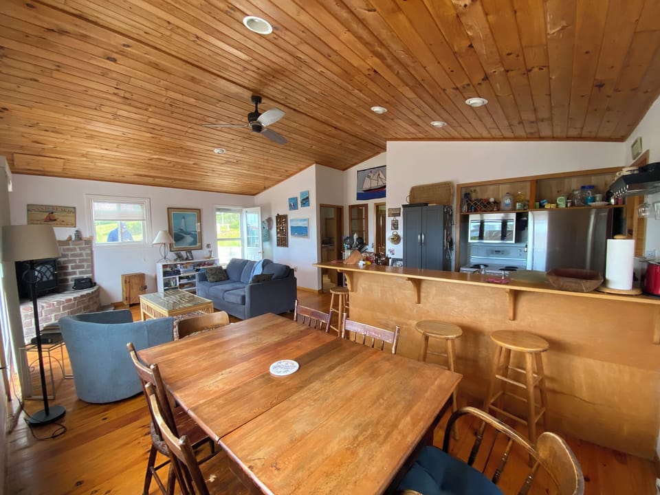 View of the dining, living room and kitchen counter.