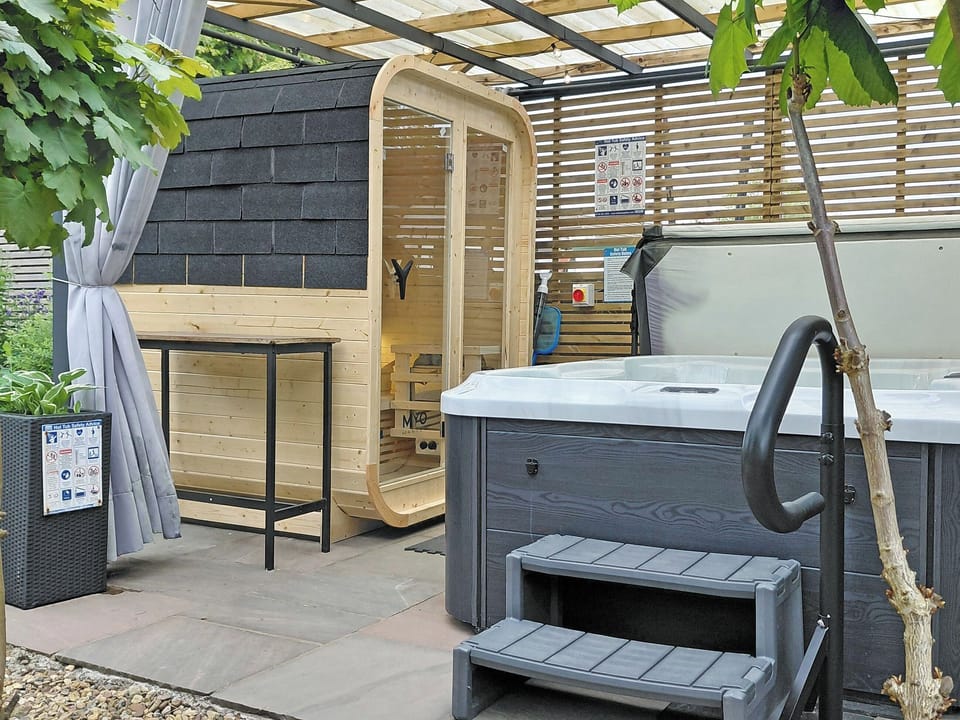 Sauna and hot tub to enjoy and relax at your home from home holiday | Sonny Cottage, Garnant, near Ammanford