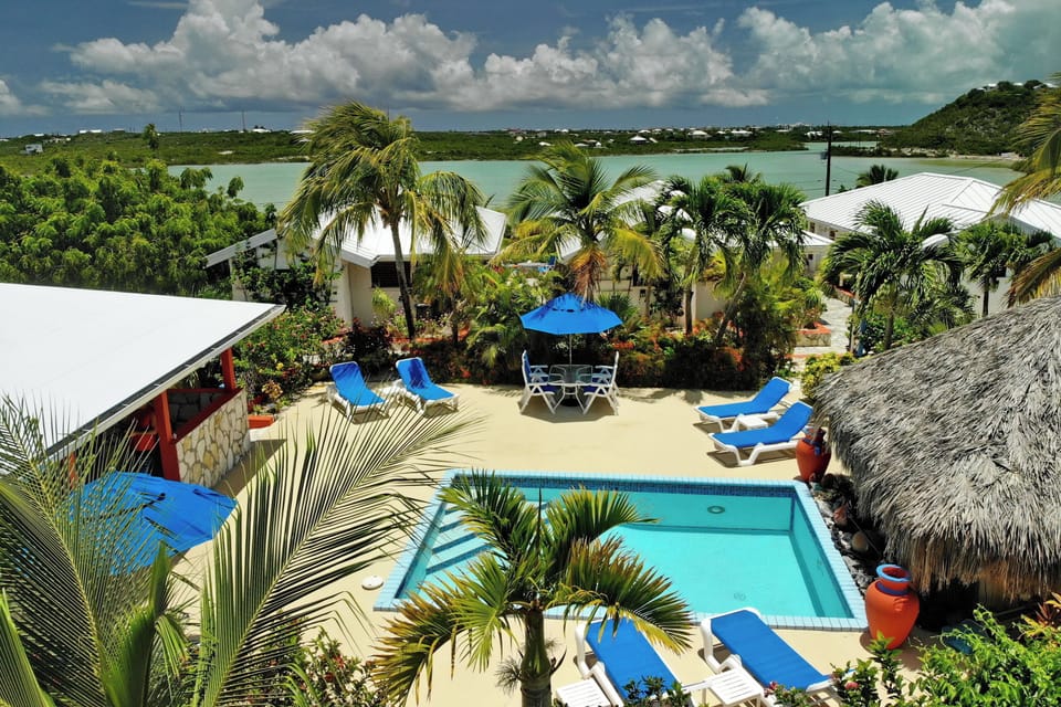 Outdoor pool, open 8:00 AM to midnight, pool umbrellas, sun loungers
