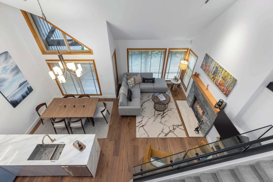 - Open-concept view of kitchen, dining, and living area below  
- Airy layout with tall ceilings and modern mountain finishes  
- Designed for connection and comfort in every corner  