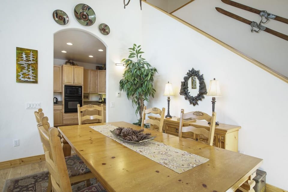 View from the dining area into the kitchen and the stairs leading up to the first and second bedrooms.