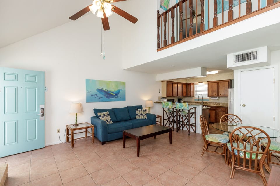 Relax in your spacious open-plan retreat with soaring ceilings, coastal decor, and a fully equipped kitchen perfect for your getaway.