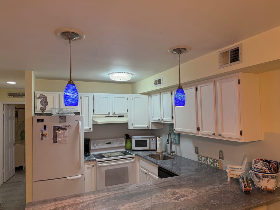 Newly renovated kitchen with granite countertops. Kitchen is fully stocked. 