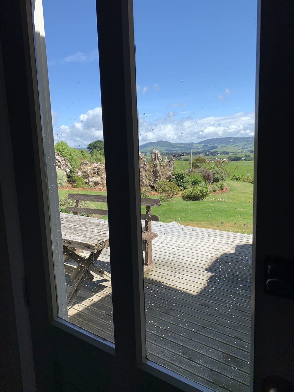 View of back deck and garden through passage door.