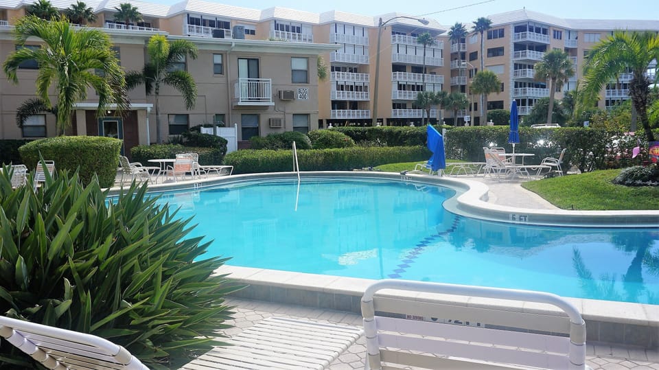 Friendly Native pool - that's unit 401 pictured behind the pool. 1st floor
