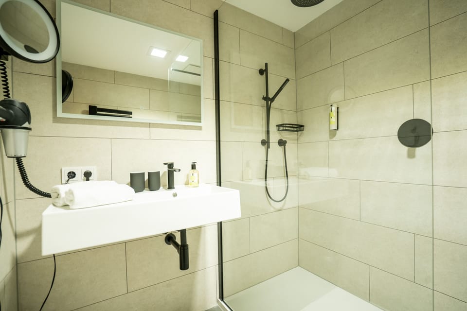Junior Studio Suite | Bathroom | Hair dryer, bathrobes, towels, soap