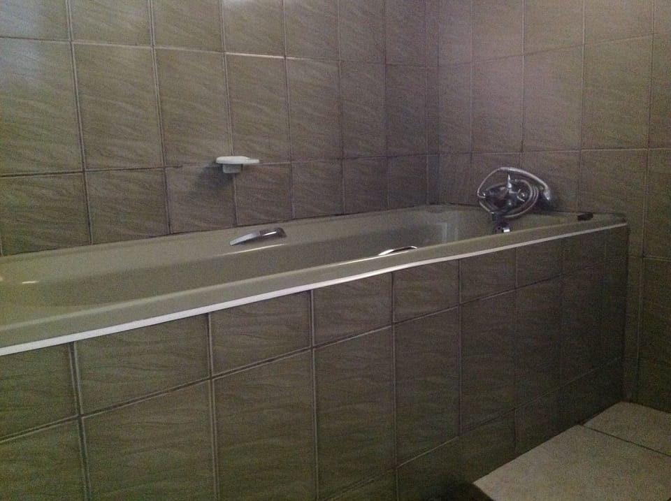 Combined shower/tub, hair dryer, slippers, towels