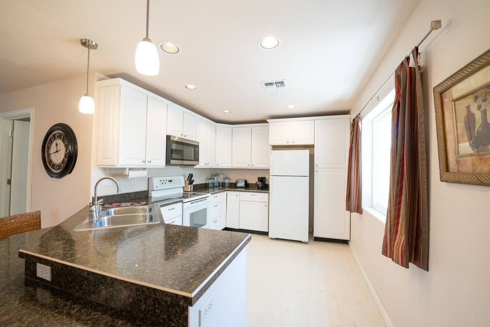 Enjoy a spacious kitchen bathed in natural light, featuring sleek granite counters and plenty of room to cook, gather, and feel at home.