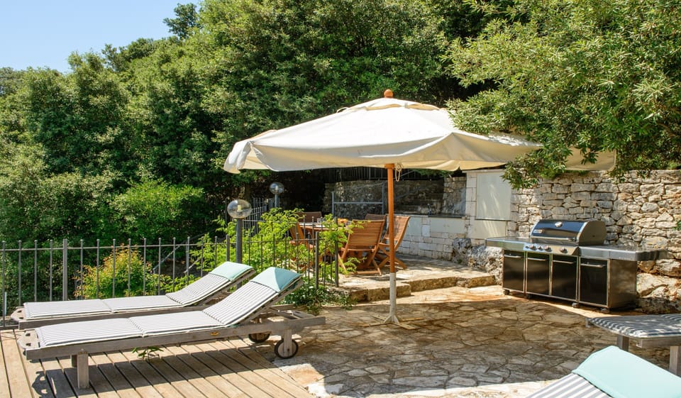 Outside kitchen with Weber barbecue range on dining terrace adjoining the pool