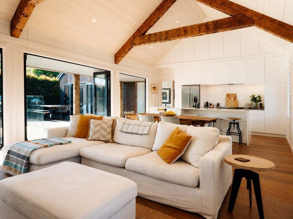 Open plan living, dining and kitchen area leading out to the entertaining deck with BBQ and pool.