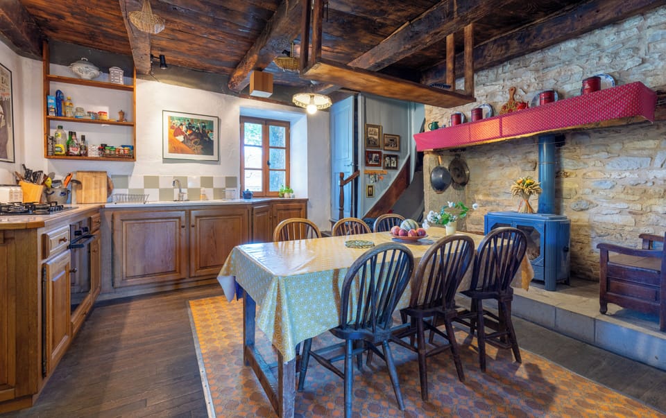 Kitchen with view to stairs and inglenook with stove