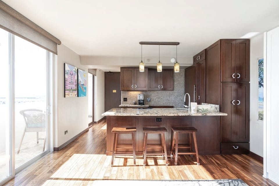Full kitchen with Thermador fridge & freezer, induction stove top, and microwave/convection oven.  Plenty of storage, kitchen items, and essentials.