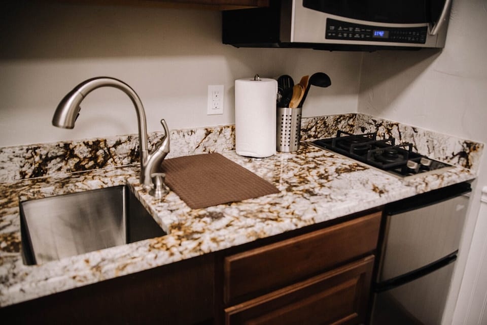 Deep sink, sprayer faucet, granite, mini freezer and fridge, & convection oven