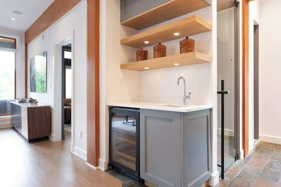- Compact bar area with sink, shelves, and beverage cooler   
- Adds function and charm to the home’s social space  
