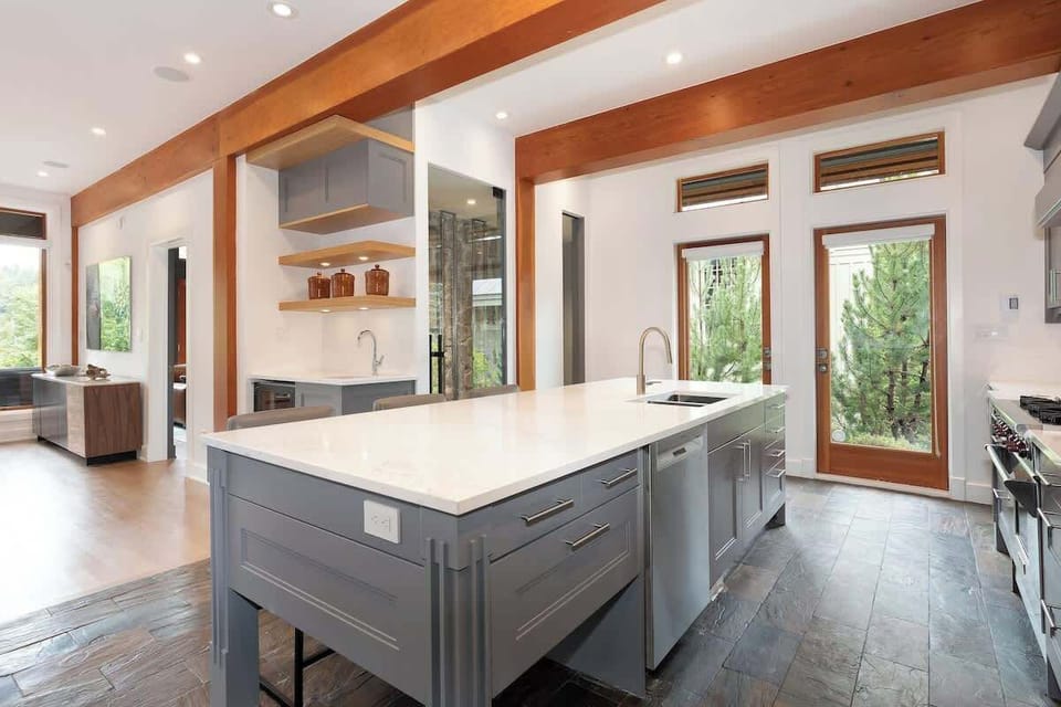 - Bright kitchen with extended counters and dual sinks for convenience  
- Easy outdoor access and natural light for perfect cooking ambiance  
- Blends modern design with mountain cabin warmth and detail  
