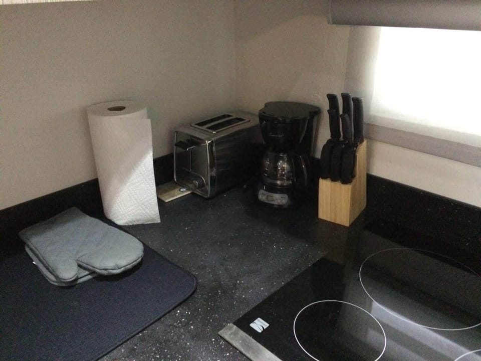 Kitchen equipped with cook top, toaster & coffee maker.