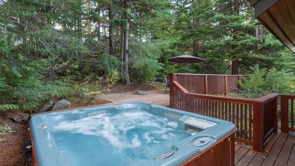- Outdoor hot tub surrounded by forest trees for a relaxing soak under the sky  
- Steam rises against the crisp mountain air creating a serene private escape  
- Perfect for unwinding after skiing or hiking through the nearby trails  