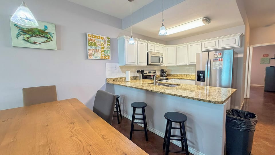 Your spacious kitchen features granite countertops, stainless steel appliances, and breakfast bar seating perfect for morning coffee.