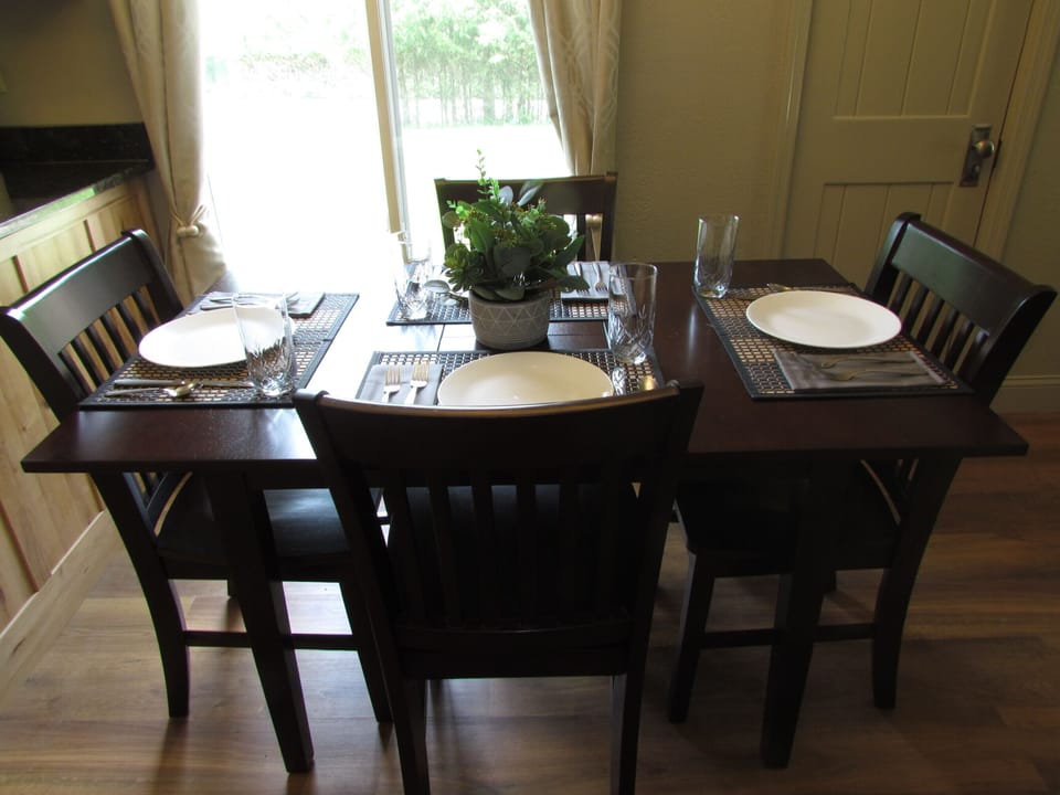 Four person dining area. Two extra chairs and two TV tables stored in closet.