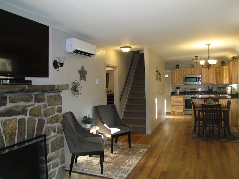 View from living room toward kitchen , dining area, sitting area, and loft stair