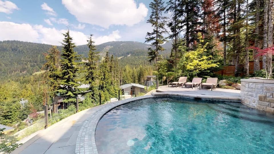 - Infinity pool overlooking forested hills and sweeping mountain scenery  
- Sun loungers and crystal-clear water make this the ultimate relaxation spot  
- Refreshing outdoor escape surrounded by whispering pines and open sky  
