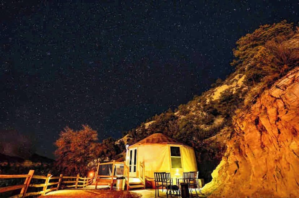 Private patio area at your yurt with outdoor seating, perfect for relaxing with morning coffee or winding down after a day of adventure.