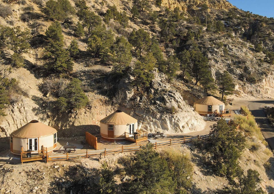 Private patio area at your yurt with outdoor seating, perfect for relaxing with morning coffee or winding down after a day of adventure.