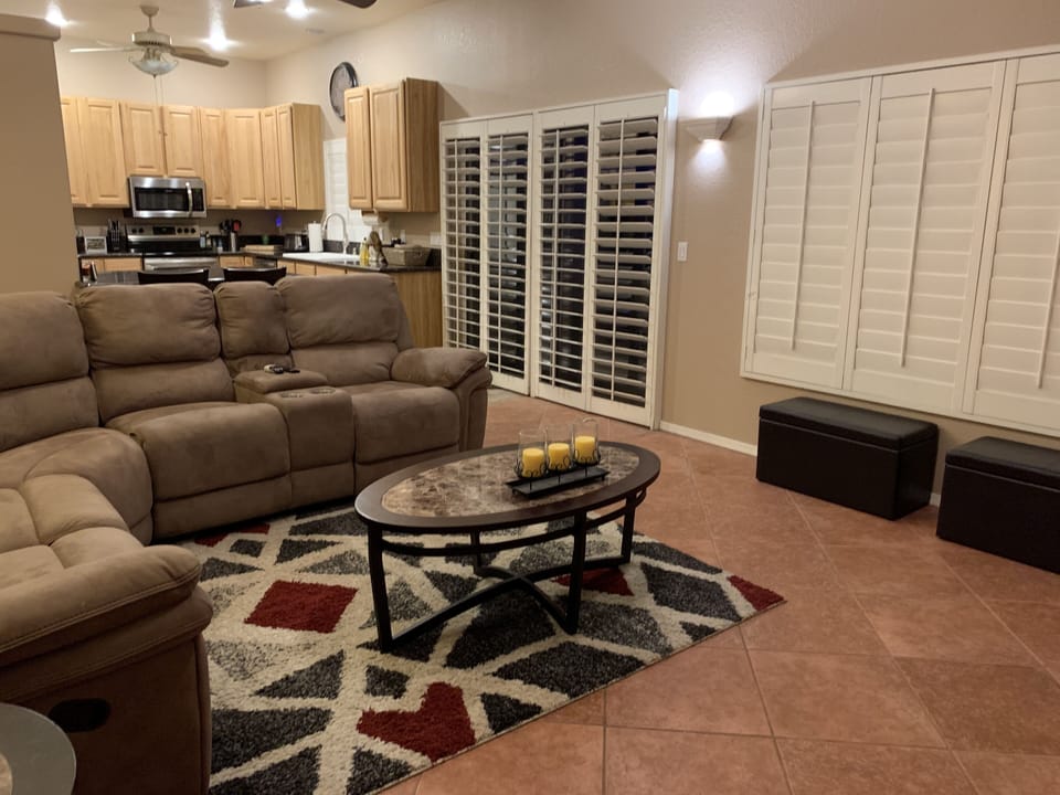 Family room looking into kitchen. 2 barstools at counter
