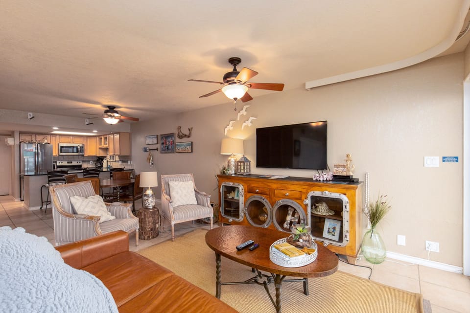 Sink into comfortable chairs while your favorite shows play on the large TV in this cozy living space.