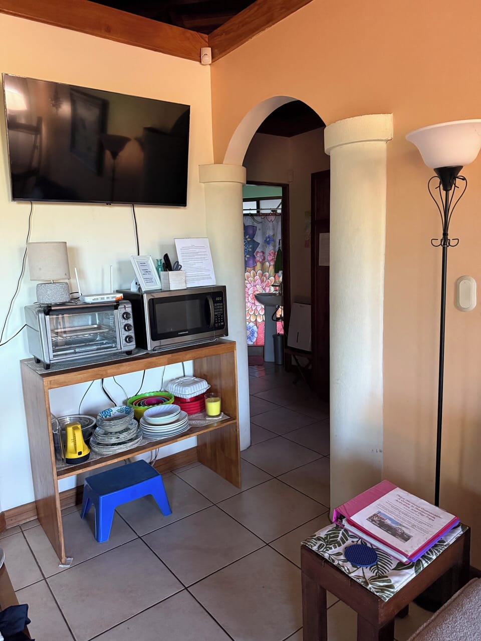 TV, toaster oven, and microwave with dishes for your convenience