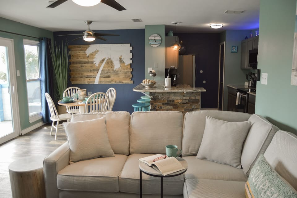 Sink into comfort in your open-concept living space, where coastal charm meets modern convenience with a sleeper sofa.