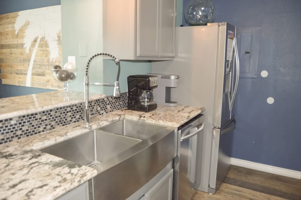 Your sleek kitchen features granite counters, stainless appliances, and a professional faucet for easy meal prep.
