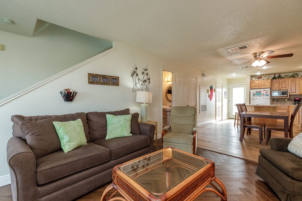 Relax in your spacious living room with comfy seating, then gather around the dining table for meals in this bright, open-concept home.