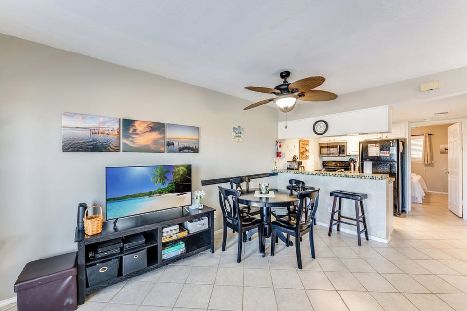 Settle into your open-concept living space with coastal artwork and a fully equipped kitchen for memorable meals together.
