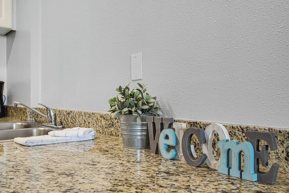 Highlight the warm reception area with a delightful combination of a welcome decor piece and a carefully chosen small plant.
