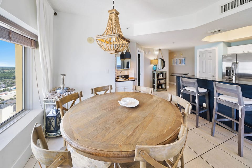 Gather around your beautiful dining table beneath the stunning chandelier while enjoying sweeping city views through floor-to-ceiling windows.