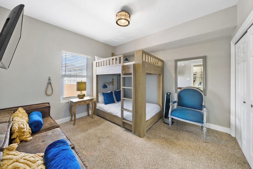 Your kids will love this cozy bunk room with plush seating, TV entertainment, and charming nautical touches throughout.