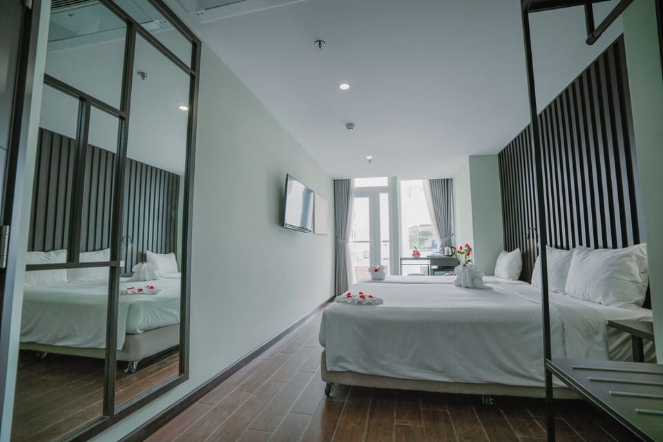 Deluxe Triple Room, Balcony, City View | Minibar, in-room safe, desk, laptop workspace