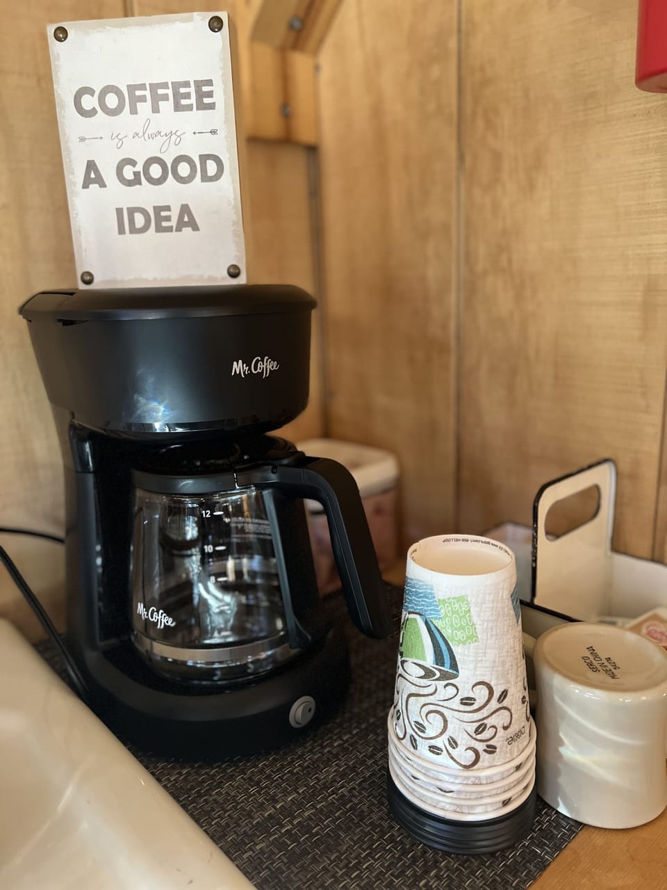 Drip coffee pot, coffee, tea, creamer and sweetener provided.