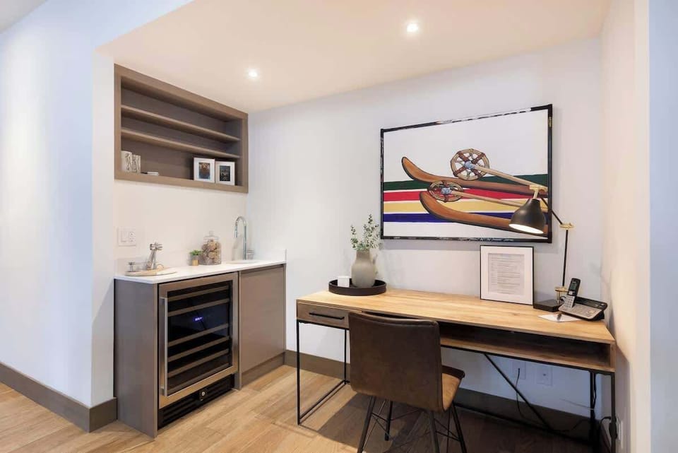 - Modern workspace with wet bar and art décor  
- Perfect corner for remote work or evening wine moments  
- Functional design meets cozy mountain luxury  