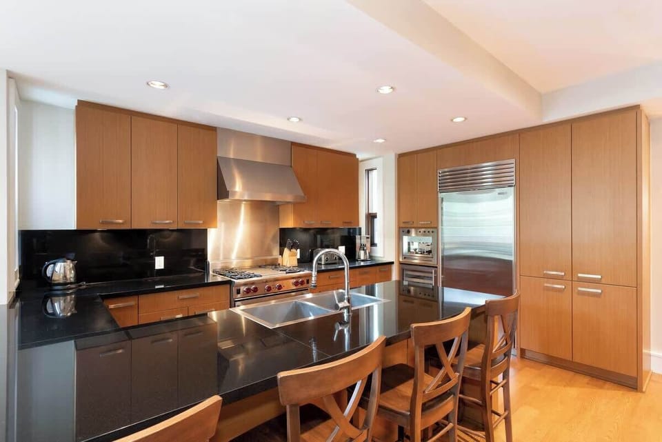 - Sleek open kitchen with granite counters and island bar seating  
- Fully equipped with premium appliances for home-style dining  
- Warm lighting and modern design make cooking a joy in the mountains  
