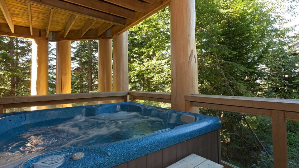 - Private outdoor hot tub surrounded by whispering pine trees  
- Relax in bubbling warmth with stunning forest scenery  
- Perfect spot to unwind after skiing or hiking the trails nearby  
