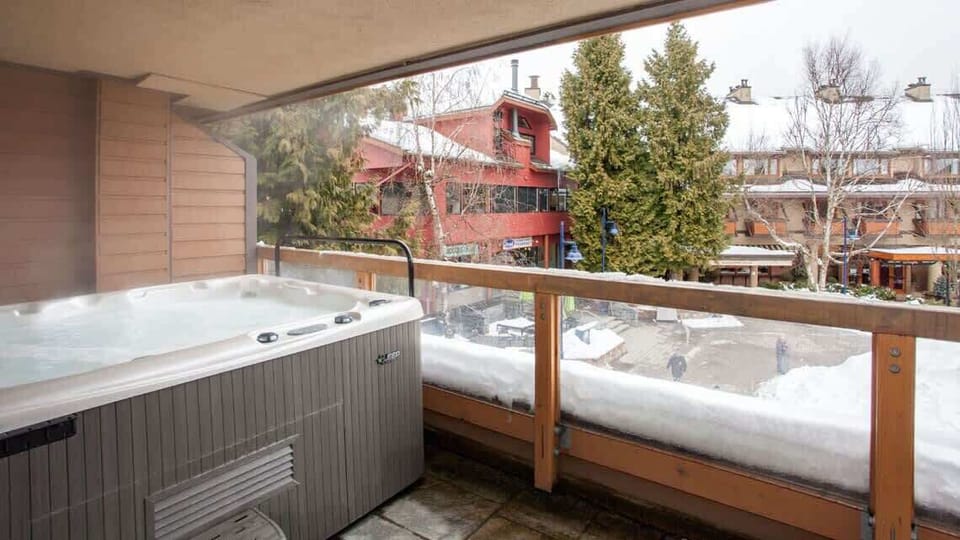 - Soak under the stars in a bubbling private hot tub with village views  
- Steam rises against crisp mountain air for ultimate relaxation  
- Ideal après-ski experience with Whistler’s charm below  
