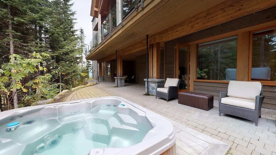 - Private hot tub on a forest-view patio for ultimate relaxation  
- Outdoor lounge area surrounded by tall evergreens and fresh air  
- Unwind in your own nature escape with cozy seating and serenity  