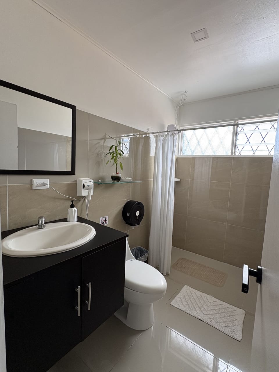 Shower, rainfall showerhead, hair dryer, towels