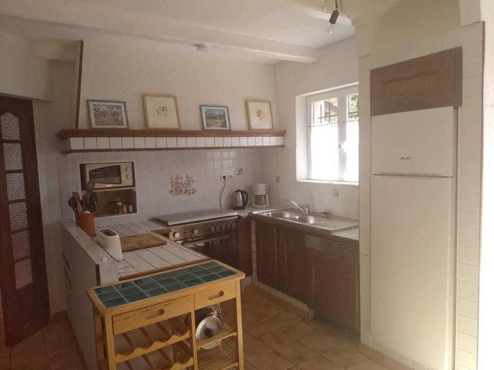 Immediately inside is the kitchen with a new oven, fridge and sink