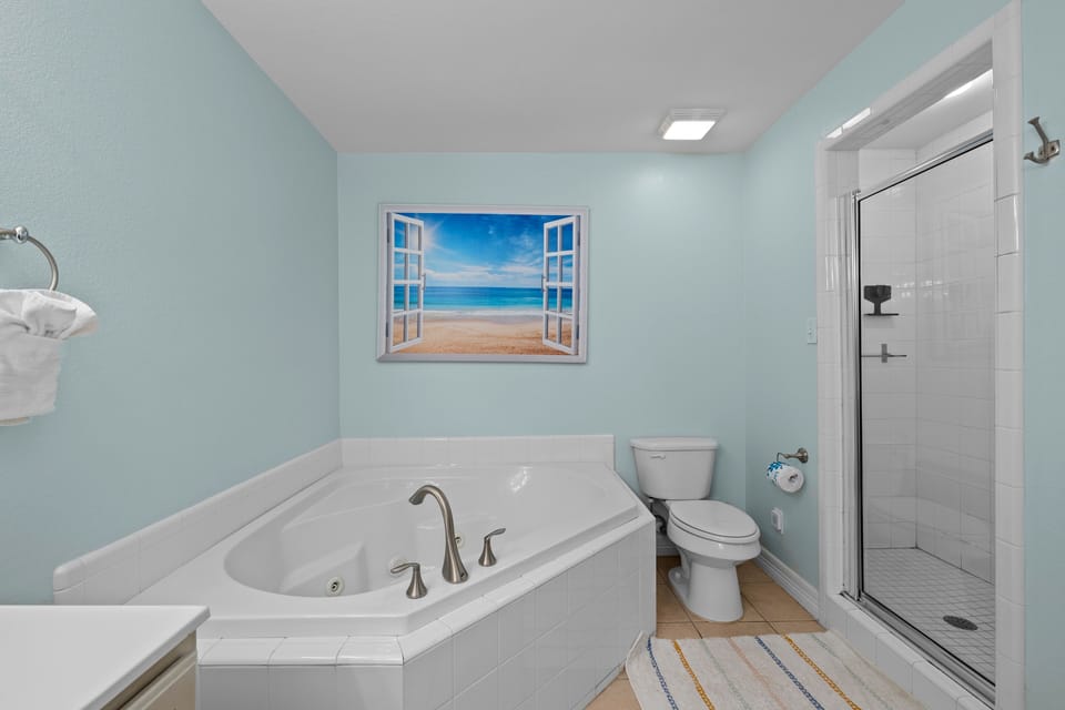 Unwind with a relaxing soak in the oversized jetted bathtub after a day at the beach.