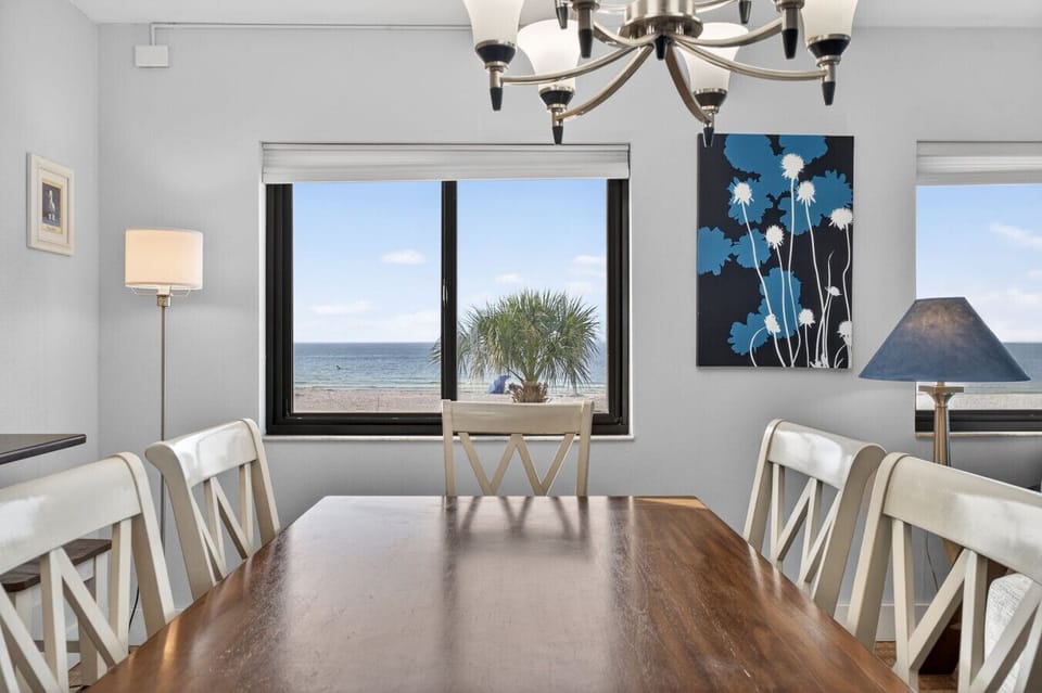 Inviting dining table set near windows, ideal for shared meals in natural light.