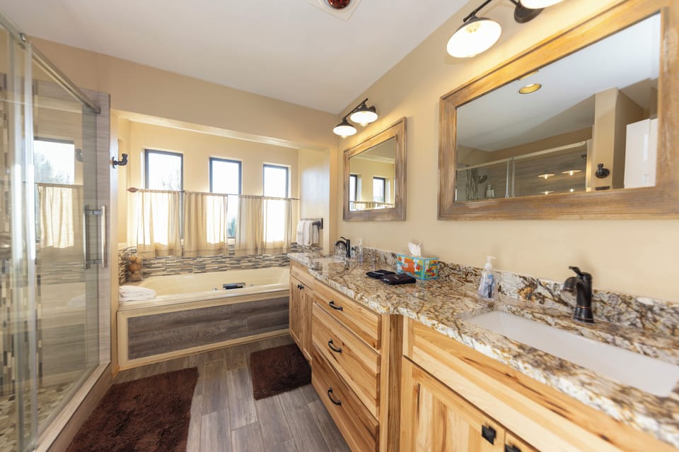 Primary bath with large walk-in shower, jetted Jacuzzi tub and double sinks