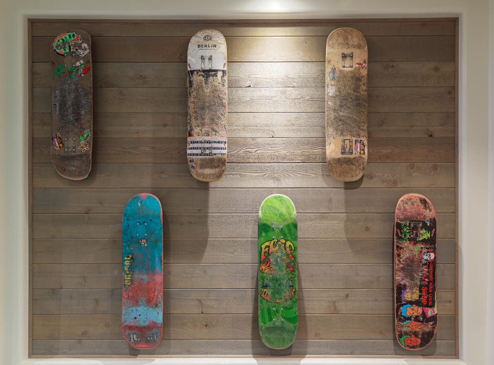 Pacifica skateboard decks decorate the lobby art wall